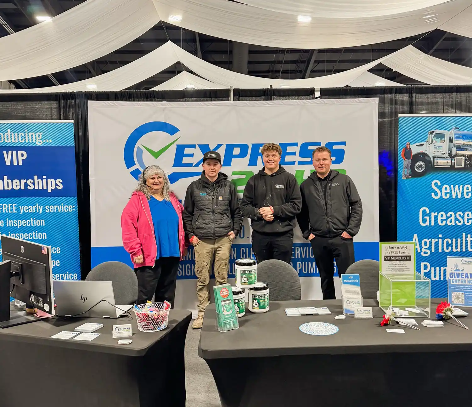 Express team members standing at the company trade-show booth